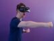 Exploring Virtual Reality (VR) Casinos: The Future of Gambling? Man Punching in the Air while in VR Goggles