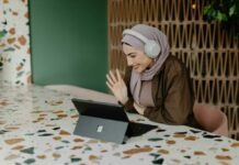 Omegle: The New Hub for Video Chat with Random Strangers a person sitting on a table with a laptop