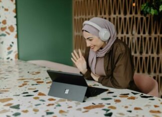 Omegle: The New Hub for Video Chat with Random Strangers a person sitting on a table with a laptop