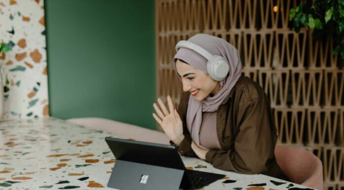 Omegle: The New Hub for Video Chat with Random Strangers a person sitting on a table with a laptop