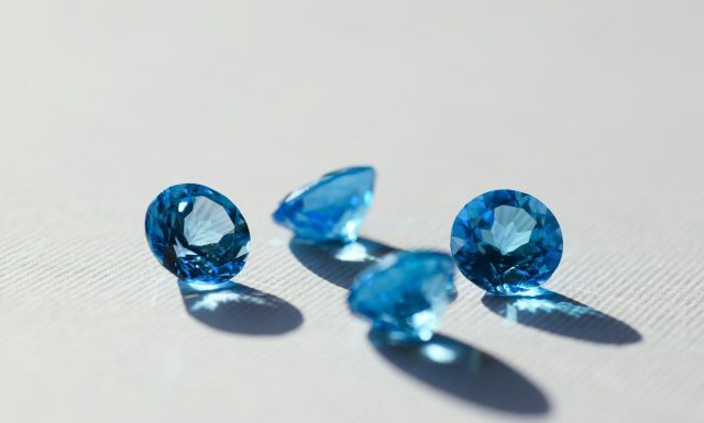 Blue Sapphire: A Stone of Beauty, Meaning, and Careful Choice blue stone on white surface