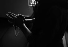 The Saving Power of Religion and its Positive Effects on Mental Health silhouette of woman holding rosary while praying