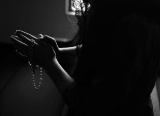 The Saving Power of Religion and its Positive Effects on Mental Health silhouette of woman holding rosary while praying