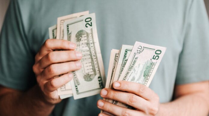 4 Common Costly Mistakes When Using a Snake Camera Crop man counting dollar banknotes