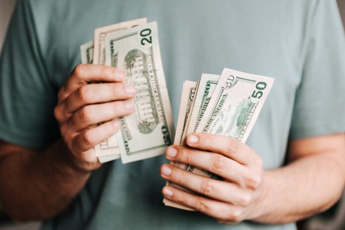 Costly Mistakes Alt-text: an image of a person counting money Crop man counting dollar banknotes