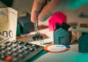 Stewardship in the Age of Algorithms: Using AI Wisely for Household Finances hand holding key over house models