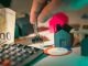 Stewardship in the Age of Algorithms: Using AI Wisely for Household Finances hand holding key over house models