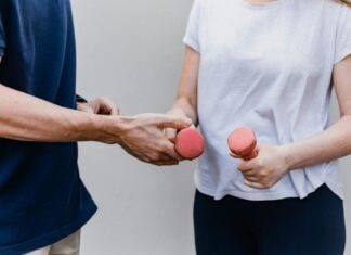 The Role of Home-Based Rehabilitation in Long-Term Recovery a man and a woman holding dumbs in their hands
