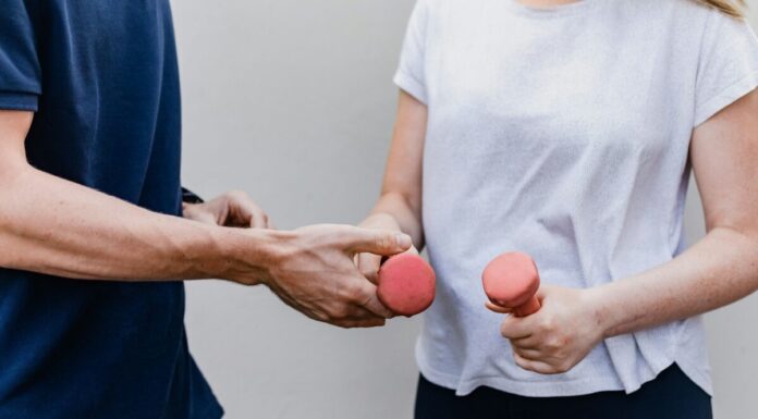 The Role of Home-Based Rehabilitation in Long-Term Recovery a man and a woman holding dumbs in their hands