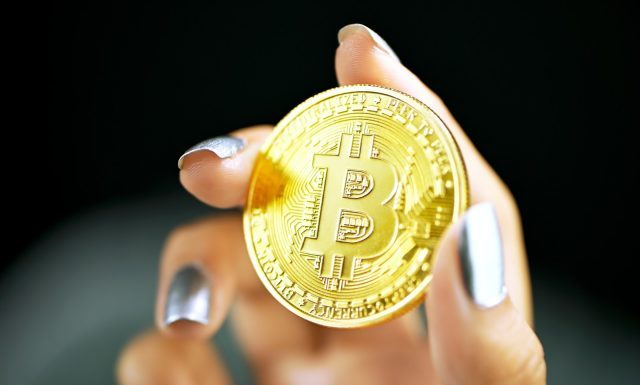 The Best Cryptocurrency Books to Read gold round coin on persons hand