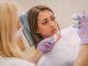 7 Secrets Your Dentist Will Never Tell You Patient of a dentist looking at fake teeth