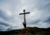 The Best Catholic Travel Destinations brown wooden cross on brown rock under white clouds during daytime