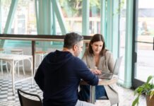 5 Tips for Succeeding as an Operations Manager man in black long sleeve shirt sitting on chair beside woman in black and white stripe