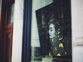 Style Queen: Audrey Hepburn’s 9 Favorite Things You’ll Be Perfect In a picture of a woman's face is seen through a window