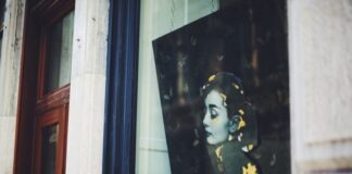 Style Queen: Audrey Hepburn’s 9 Favorite Things You’ll Be Perfect In a picture of a woman's face is seen through a window