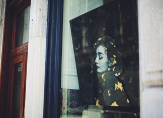 Style Queen: Audrey Hepburn’s 9 Favorite Things You’ll Be Perfect In a picture of a woman's face is seen through a window