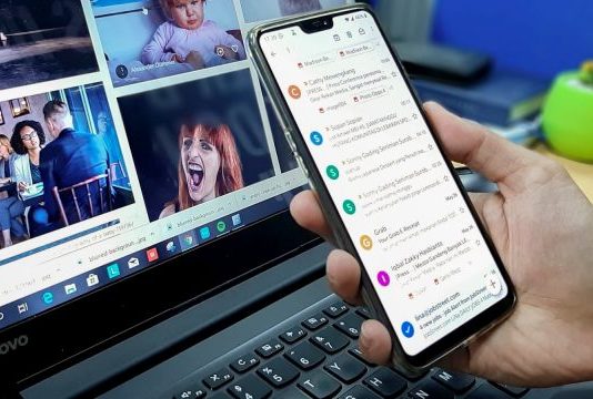 How to Use A/B Testing to Improve Your Email Open and Click Rates person using smartphone and laptop computer