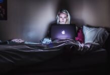 5 Online Strategies That Drive B2B Sales woman sitting on bed with MacBook on lap