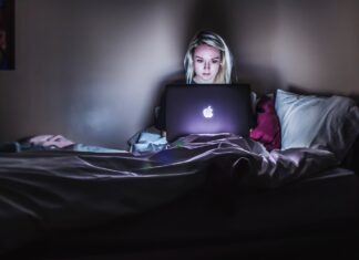 5 Online Strategies That Drive B2B Sales woman sitting on bed with MacBook on lap