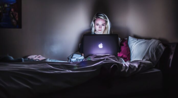 5 Online Strategies That Drive B2B Sales woman sitting on bed with MacBook on lap