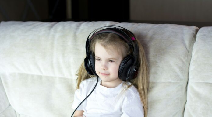 2024 Review Of Salfeld Child Control: Watching Over Kids While On The Internet a little girl sitting on a couch with headphones on