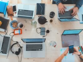 Your Business’ Tech Gear Is Getting Old? Here’s How to Upgrade Your IT Equipment Without Breaking the Bank people sitting down near table with assorted laptop computers