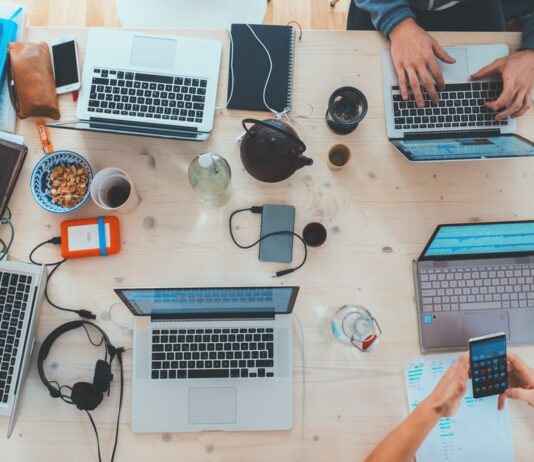 Your Business’ Tech Gear Is Getting Old? Here’s How to Upgrade Your IT Equipment Without Breaking the Bank people sitting down near table with assorted laptop computers