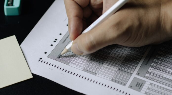 How To Choose The Best Possible GMAT Section Order For You person writing on white paper