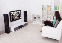 Best Forms Of Entertainment From Home Side View Of Young Woman Watching TV In Living Room Stock Photo, Picture And Royalty Free Image. Image 27021461.