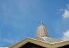 A Veteran’s Encounter with Divine Joy: Faith Lessons from a Near-Death Experience white concrete cross on top of roof under blue sky during daytime