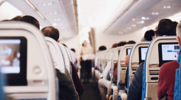 3 Reasons You Need a Travel Pillow shallow focus photography of people inside of passenger plane