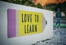 Stay Motivated when Learning a Language: 5 Tips love to learn pencil signage on wall near walking man