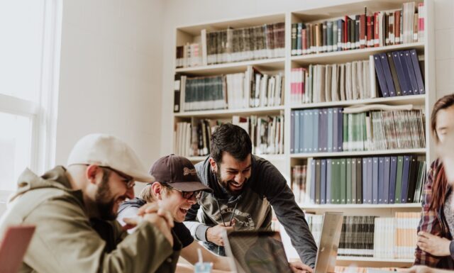 Unleashing the Excitement: Explore the Thrills of Online Gaming with Slot 88 Resmi three men laughing while looking in the laptop inside room