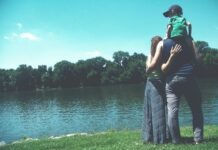 About the Family Budget: How to Control Your Funds father, mother, and son standing on grass lawn near at body of water during daytime